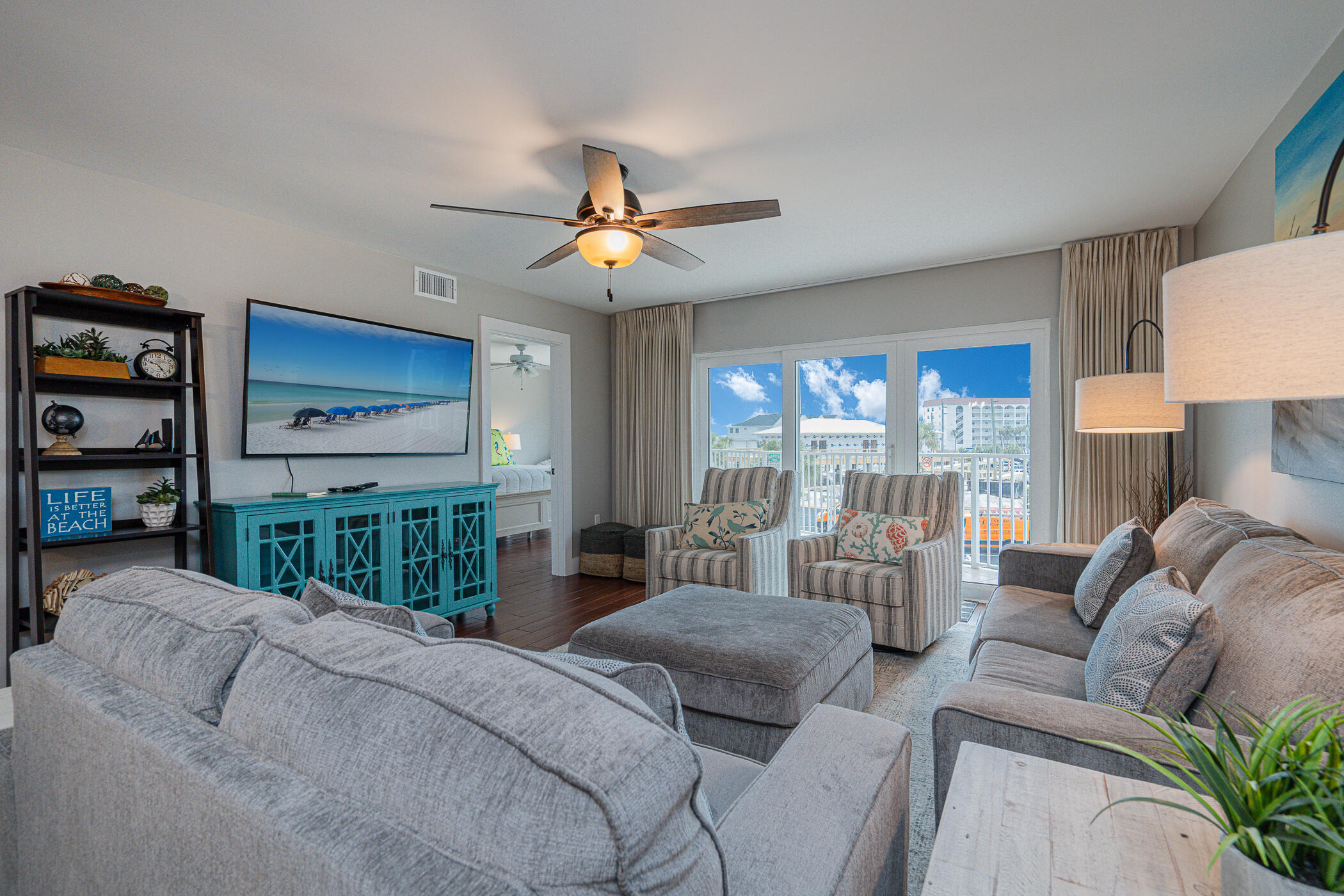 895 Santa Rosa Boulevard, Unit 308 Fort Walton Beach, FL 32548 - Photo 11 of 31 a living room with furniture a ceiling fan and a large window