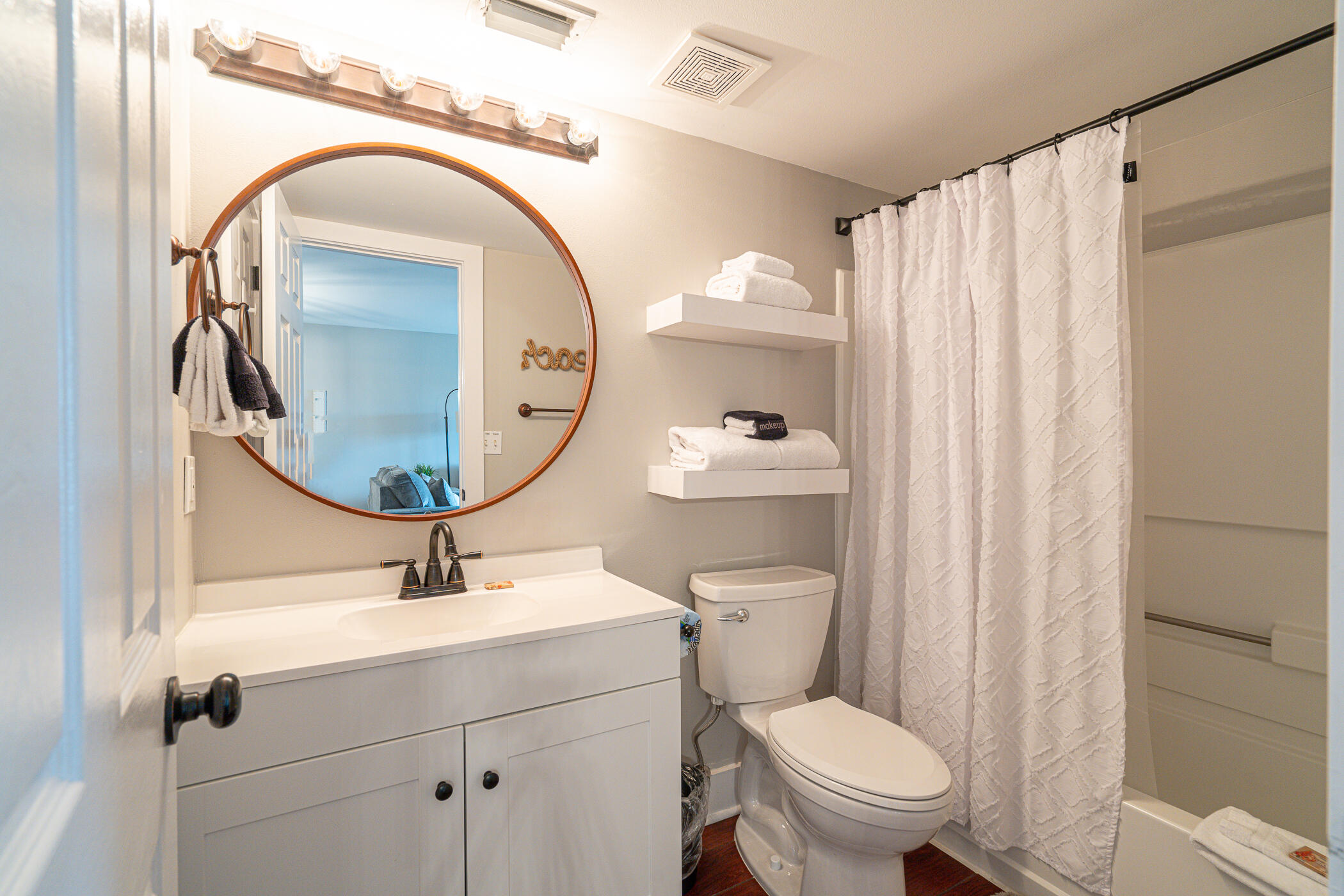 895 Santa Rosa Boulevard, Unit 308 Fort Walton Beach, FL 32548 - Photo 13 of 31 a bathroom with a toilet sink and mirror