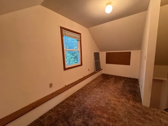 a view of an empty room and fire place