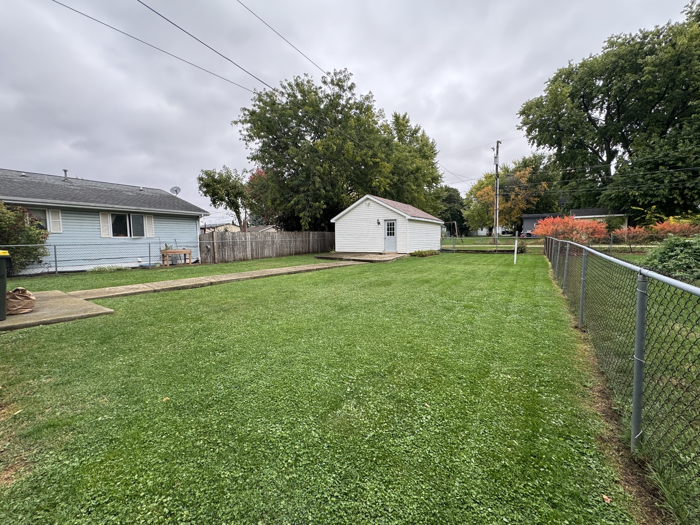 138 North Brown Street Genoa, IL 60135 - Photo 26 of 30 a view of a house with a yard and sitting area