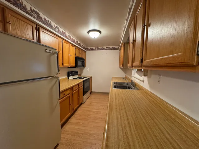 a kitchen that has a sink and a stove