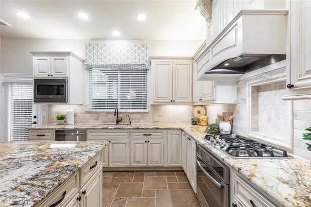 a kitchen with a sink stove top oven and cabinets