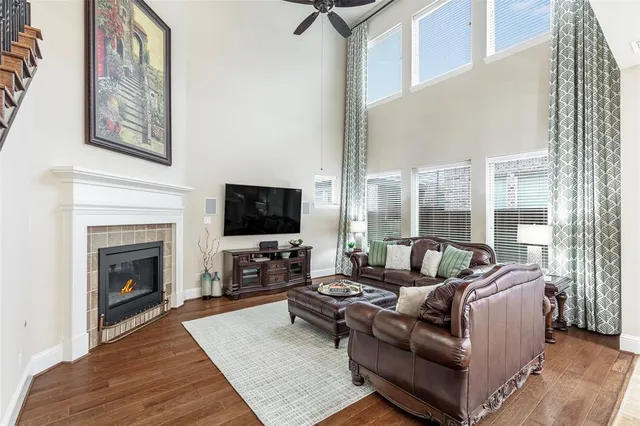 a living room with furniture a fireplace and a flat screen tv