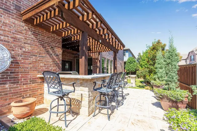 a view of a patio with table and chairs and potted plants