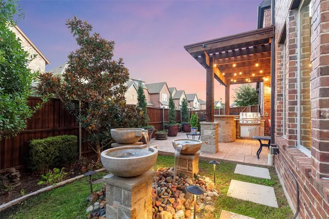 a view of a patio with couches table and chairs and potted plants