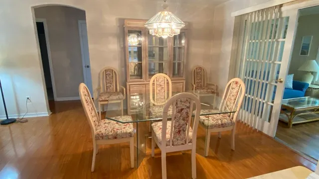 a view of a dining room with furniture and chandelier