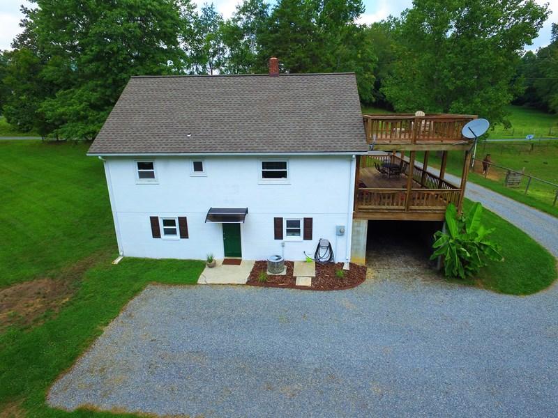 2412 Dugspur Road Callaway, VA 24067 - Photo 32 of 35 a front view of a house with a garden and trees