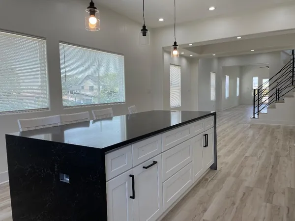 a kitchen with granite countertop a sink and a stove