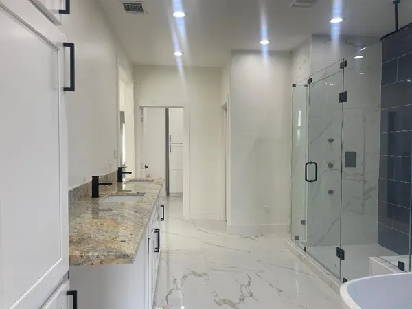 a bathroom with a shower and a sink