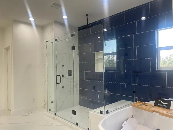 a bathroom with a bathtub and shower