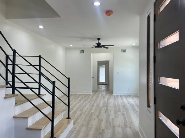 a view of a hallway with a chandelier