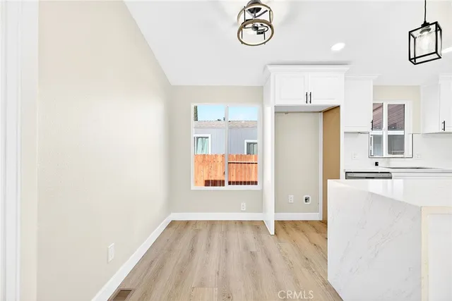 a view of a kitchen with a sink and a refrigerator