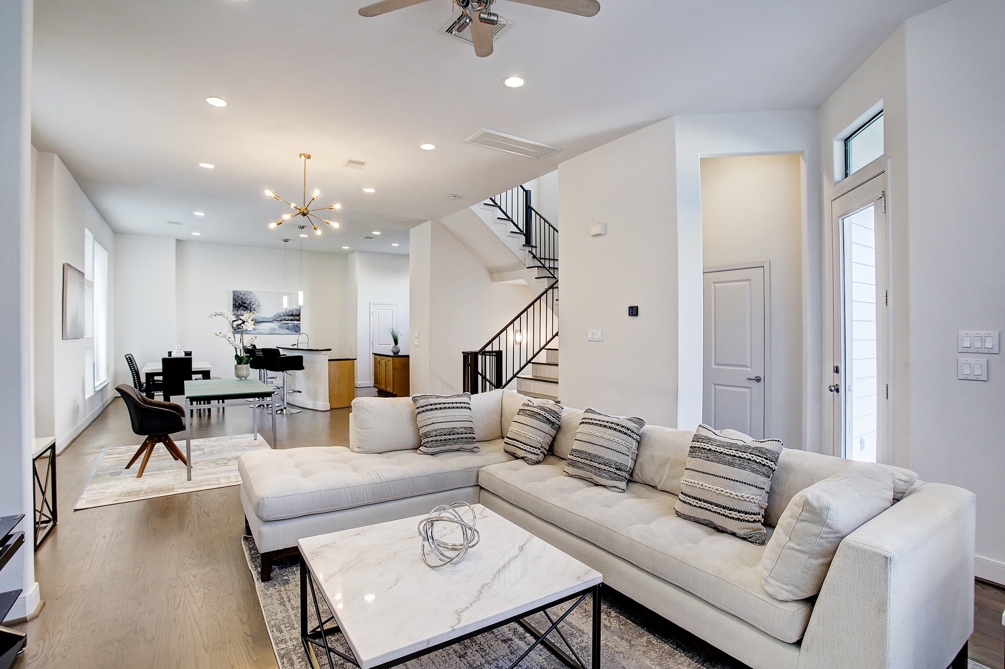 a living room with furniture and wooden floor