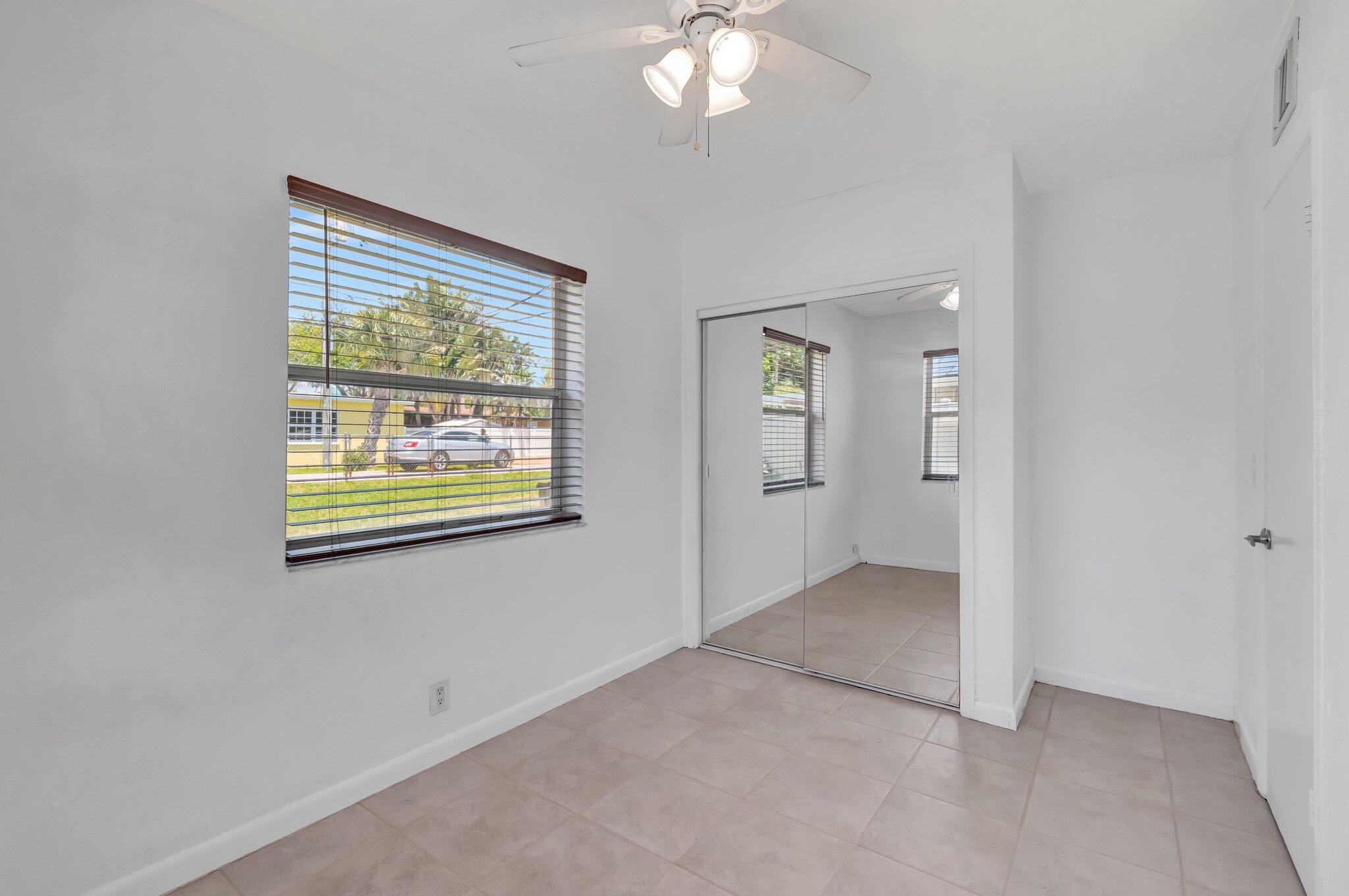 706 Southeast 4th Avenue, Unit 706 Delray Beach, FL 33483 - Photo 11 of 13 an empty room with windows and entrance