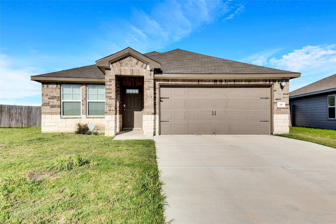 310 Low Bramble Drive Hutto, TX 78634 - Photo 1 of 1 a front view of a house with a yard and garage