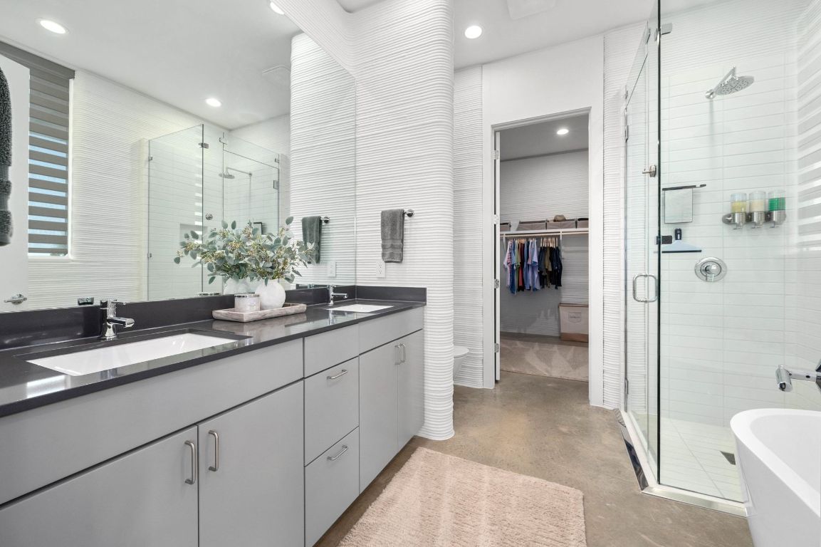 221 Lone Ranger Trail Georgetown, TX 78628 - Photo 16 of 35 a spacious bathroom with a sink and a mirror a toilet a shower