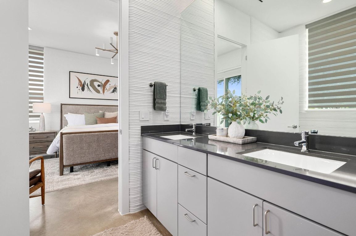221 Lone Ranger Trail Georgetown, TX 78628 - Photo 19 of 35 a en suite bathroom with double sink and a bathtub