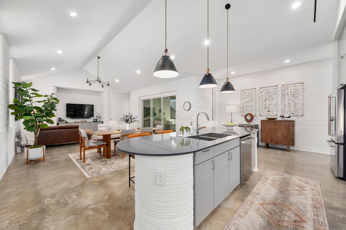 221 Lone Ranger Trail Georgetown, TX 78628 - Photo 8 of 35 a kitchen with sink stove and living room view