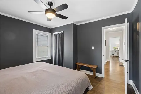 a bedroom with bed and wooden floor