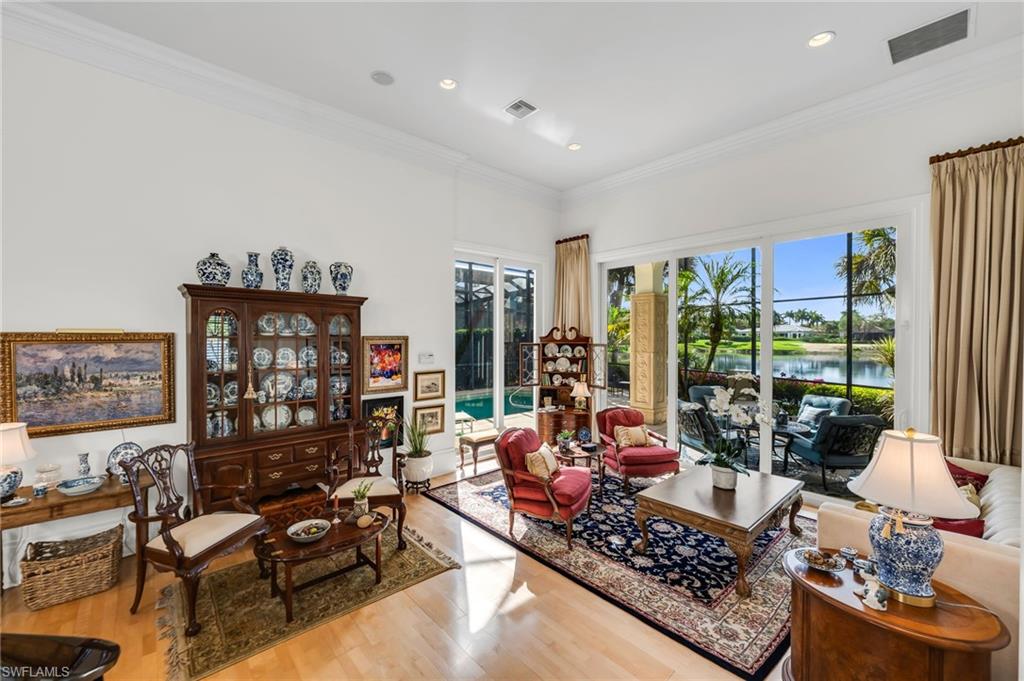 2629 Sorrel Way Naples, FL 34105 - Photo 14 of 43 a living room with furniture and a floor to ceiling window