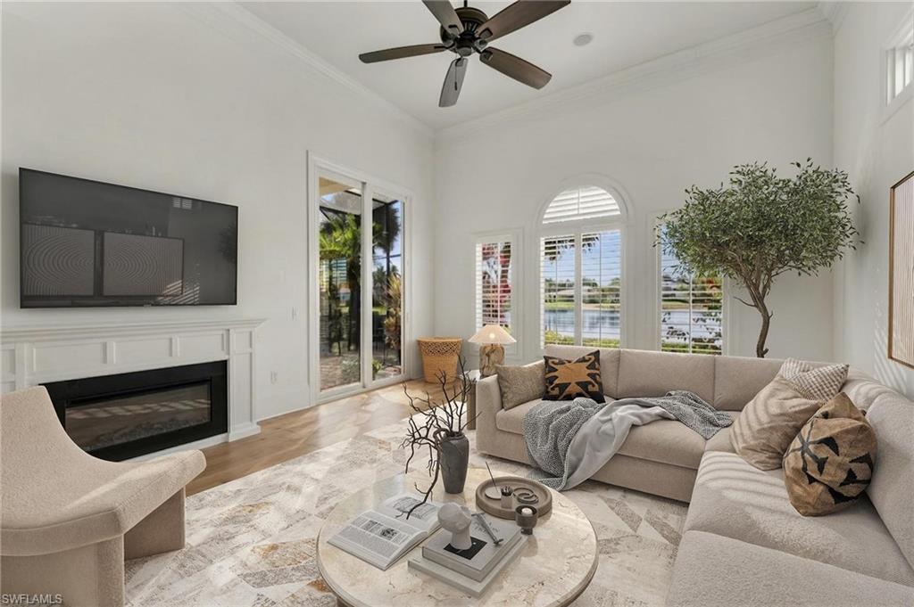 2629 Sorrel Way Naples, FL 34105 - Photo 18 of 43 a living room with furniture a fireplace and a flat screen tv