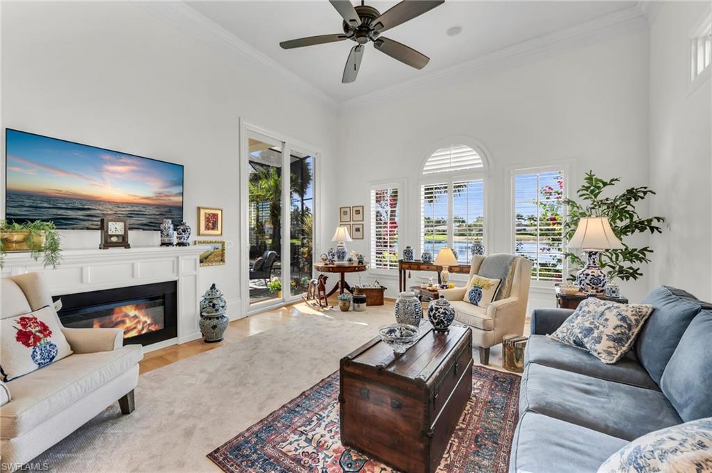 2629 Sorrel Way Naples, FL 34105 - Photo 19 of 43 a living room with furniture fireplace and a large window