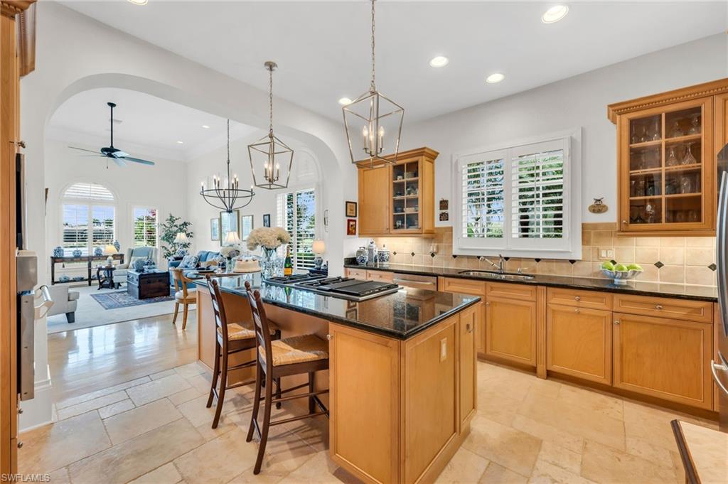 2629 Sorrel Way Naples, FL 34105 - Photo 22 of 43 a kitchen with stainless steel appliances granite countertop table chairs and a sink