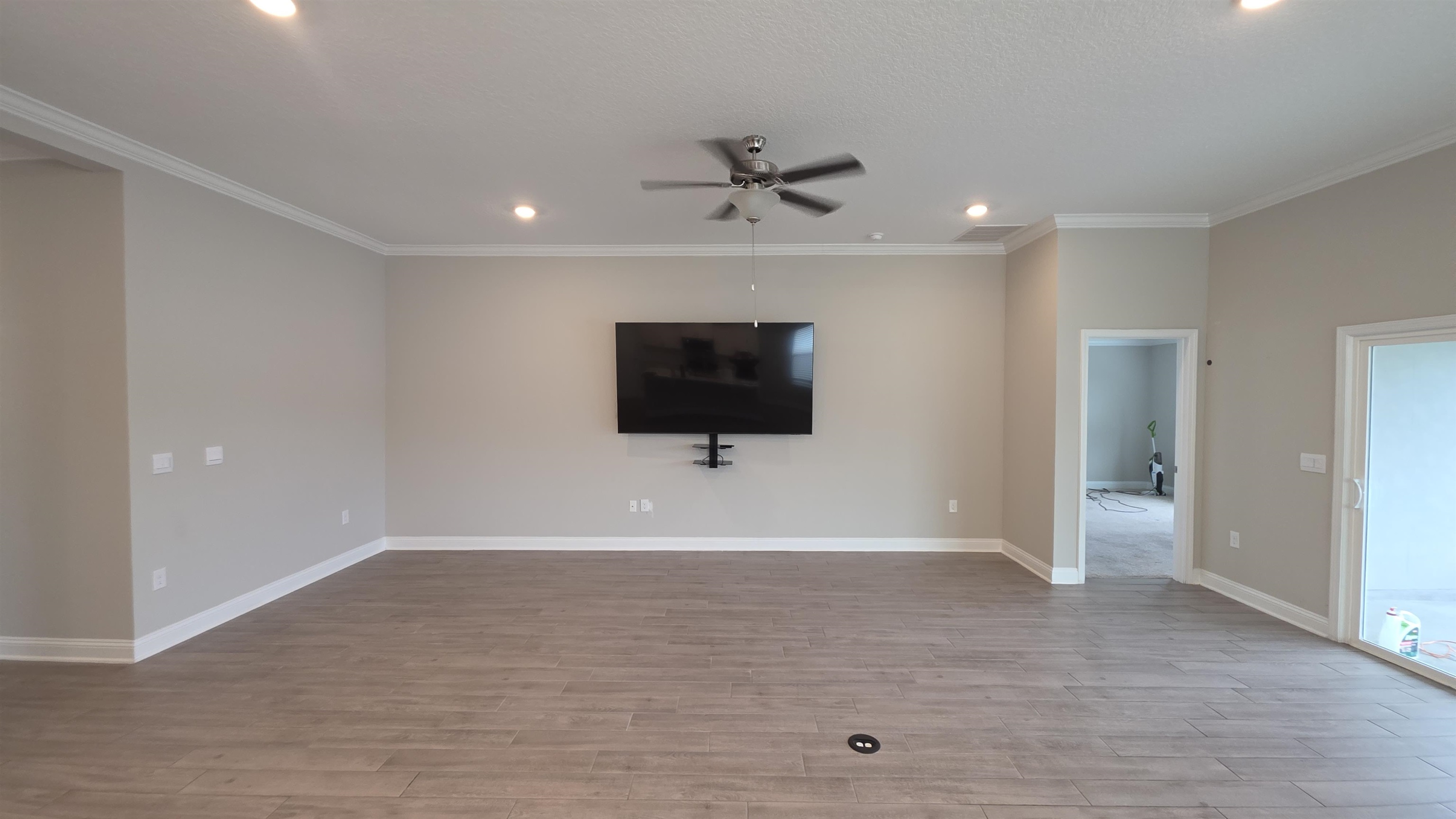 721 Navarez Street St. Augustine, FL 32084 - Photo 6 of 34 a view of a livingroom with wooden floor and a ceiling fan