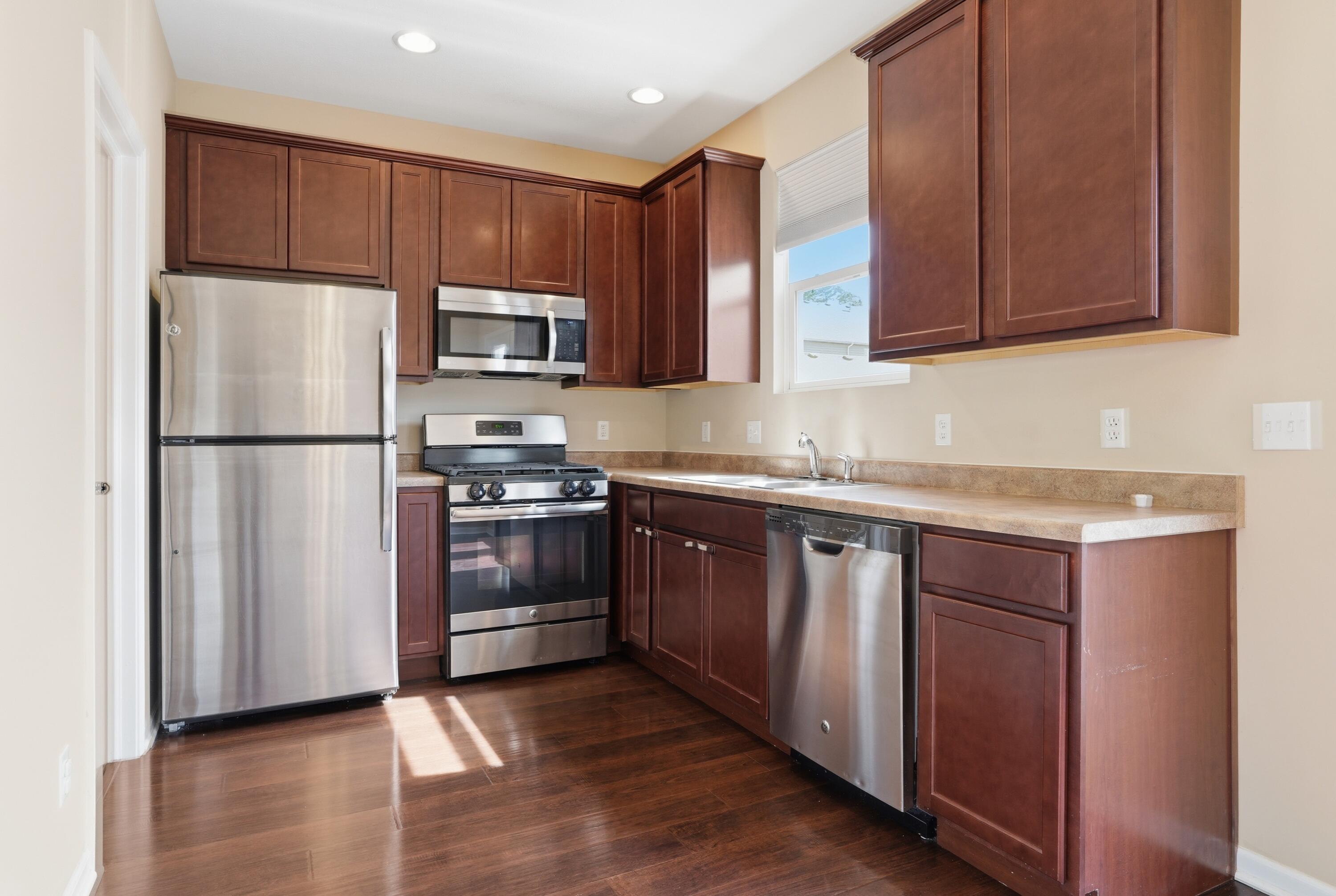 11351 Rhode Island Street Crown Point, IN 46307 - Photo 6 of 18 a kitchen with granite countertop wooden cabinets and stainless steel appliances