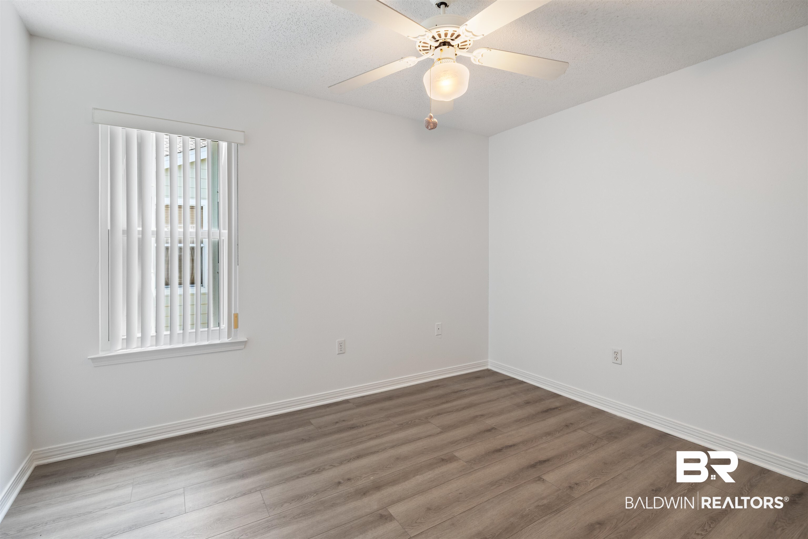 3200 Loop Road, Unit 96 Orange Beach, AL 36561 - Photo 30 of 49 Interior space featuring wood-finish flooring, white walls, and a ceiling fan with integrated lighting