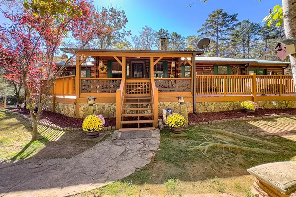 a view of a swimming pool with a patio and wooden fence