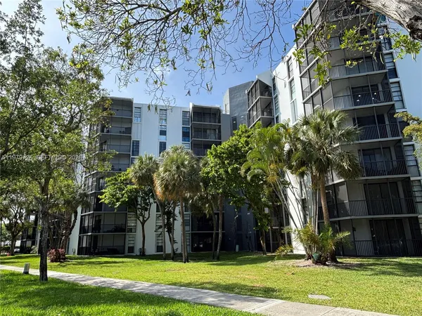 a view of a building with a yard
