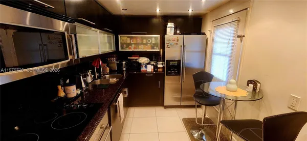 a kitchen with stainless steel appliances a refrigerator and a microwave