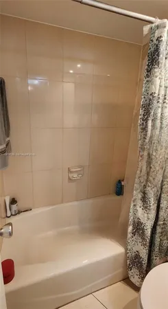 a bathroom with a toilet a sink and a shower