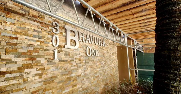 a front view of a building with trees
