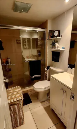 a white toilet sitting next to a bathroom sink