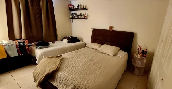 a bedroom with a bed and a flat tv screen