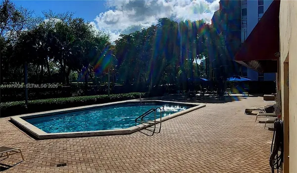 a living room with furniture and a lamp