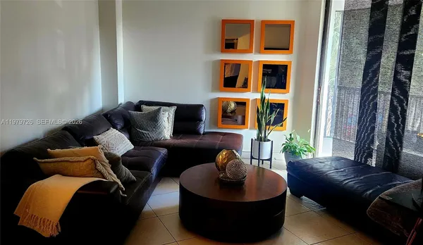 a view of a livingroom with furniture and a window