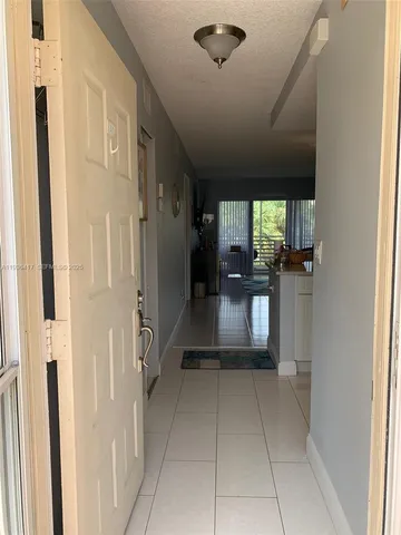a view of a hallway with a living room
