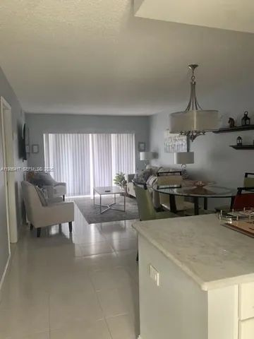 a kitchen with sink refrigerator and couch