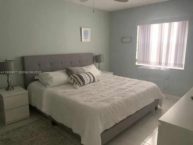 a bedroom with bed and window