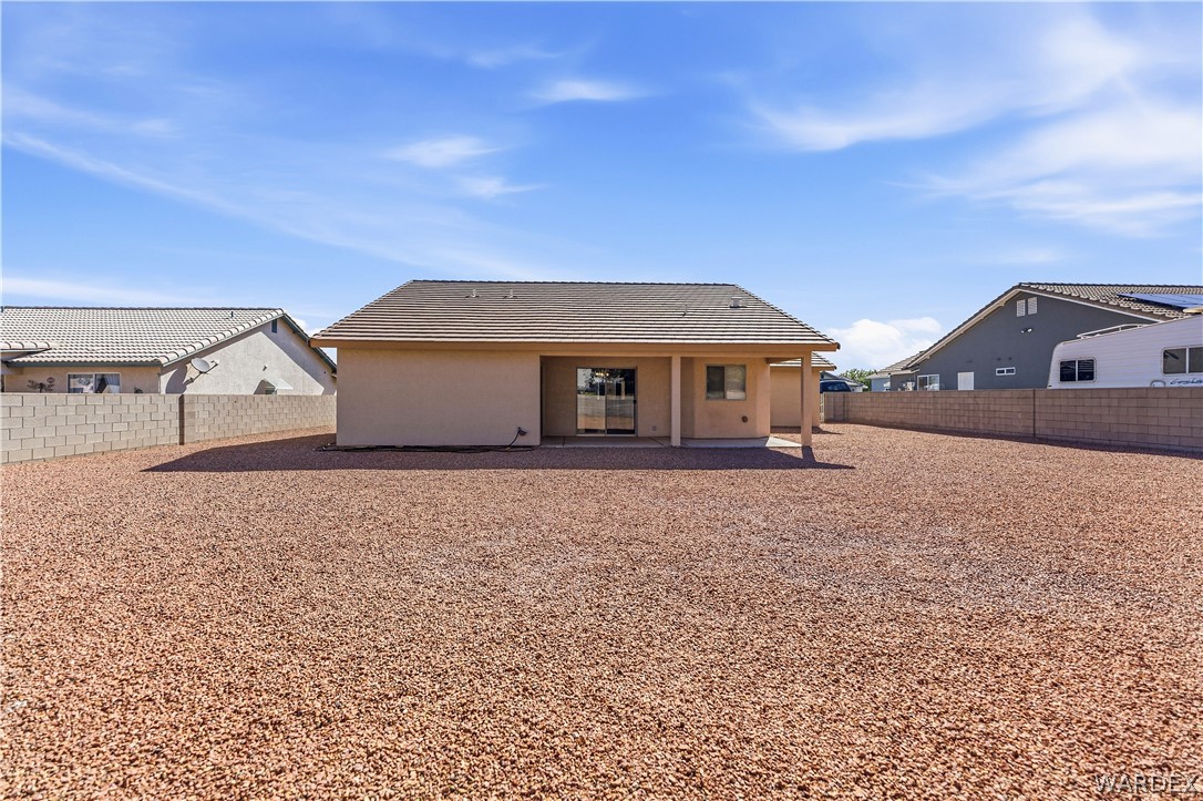 3973 Prairie View Drive Kingman, AZ 86409 - Photo 29 of 34 The property features an extensive backyard with gravel landscaping and solid block walls