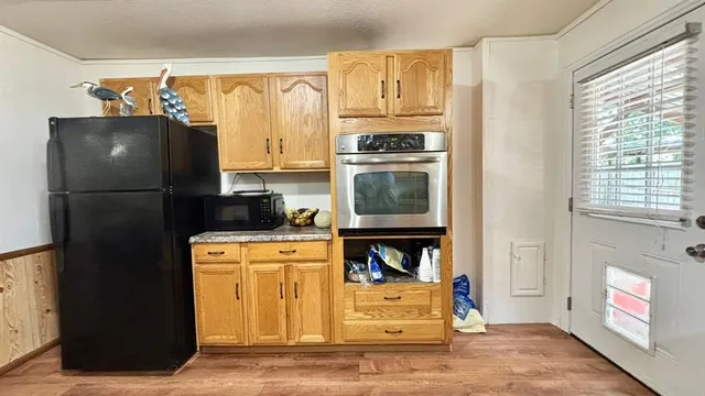 a kitchen with stainless steel appliances a refrigerator and a stove