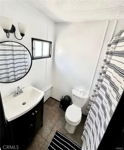 a bathroom with a sink toilet and mirror