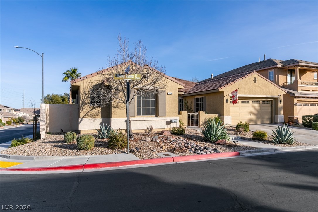 7524 Midnight Rambler Street Las Vegas, NV 89149 - Photo 3 of 51 A well-maintained desert landscape frames this welcoming residence with a convenient two-car garage.