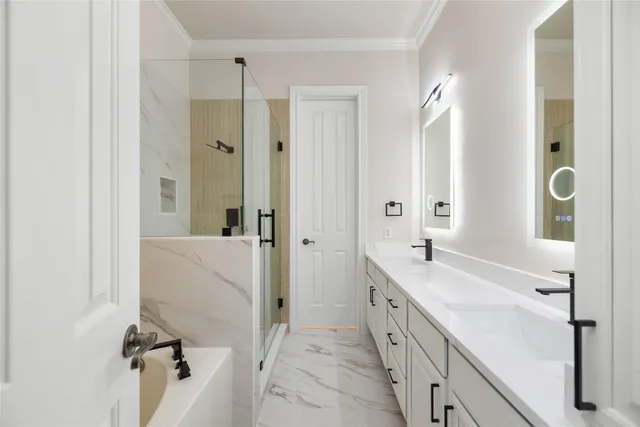 a spacious bathroom with a double vanity sink a mirror and a bathtub
