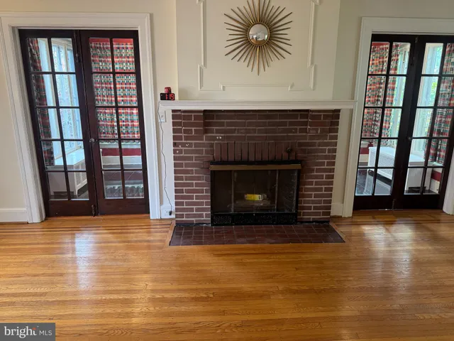 a view of an empty room with window and fireplace