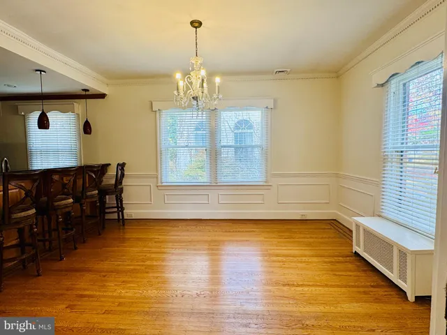 a view of a livingroom with furniture wooden floor and chandelier