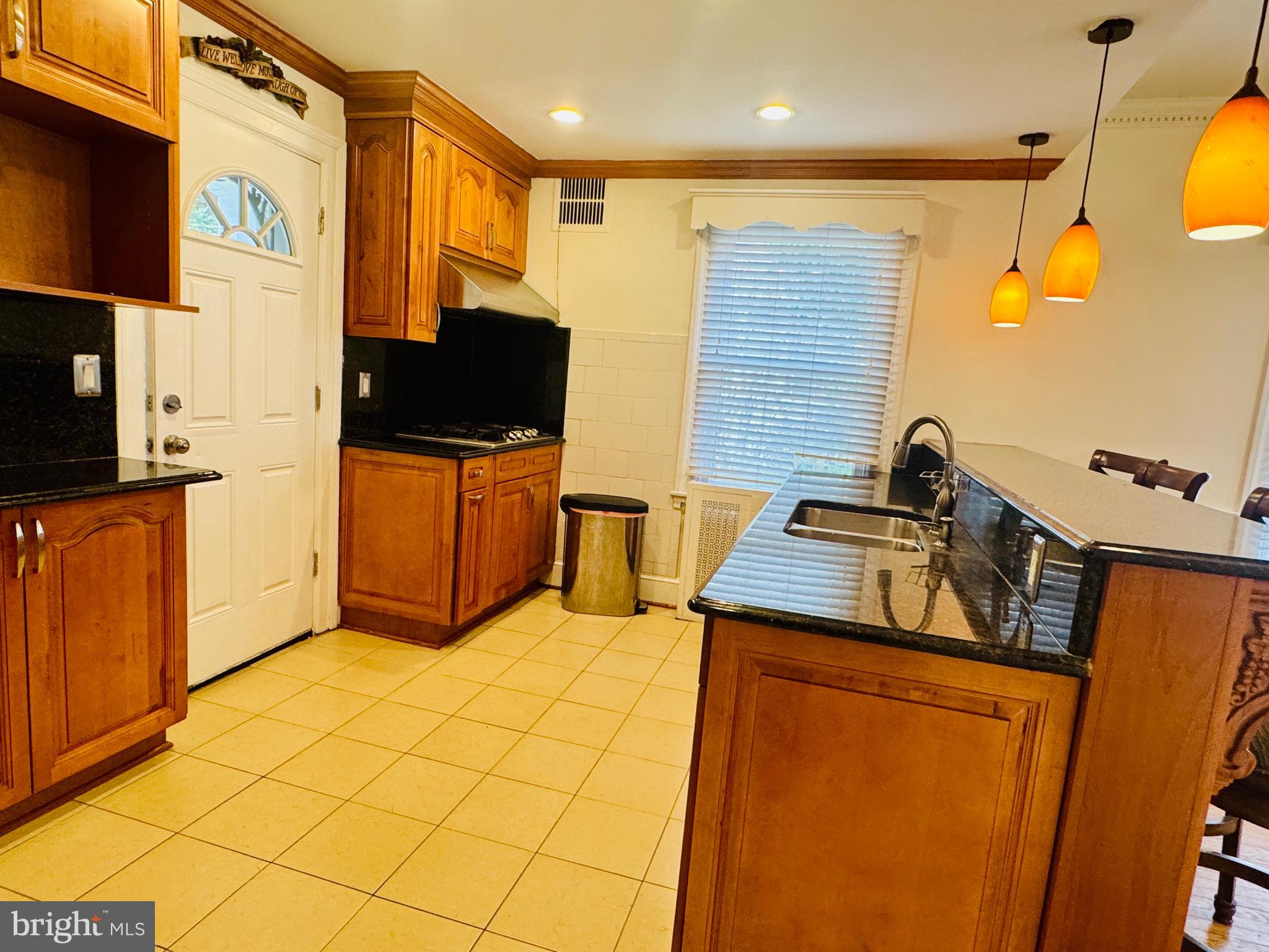 3902 Hadley Square West Baltimore, MD 21218 - Photo 8 of 38 a kitchen that has a sink and a stove top oven